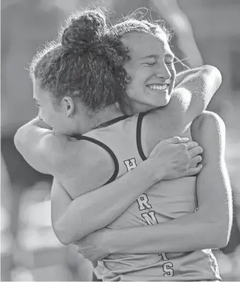  ?? MATT DAYHOFF/JOURNAL STAR ?? Eureka runners celebrate after the Hornets' third-place finish in the 4X100-meter relay during the girls Class 2A sectional track and field meet on Wednesday at Metamora High School.