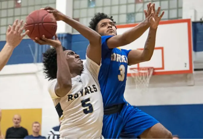  ?? Steph Chambers/Post-Gazette ?? Vincentian Academy’s Alex Griggs shoots as Cornell’s Isaiah Langston defends Friday night. Class 1A No. 2 Vincentian beat No. 1 Cornell, 70-59, to win Section 1.