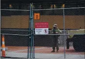  ?? JIM MONE — THE ASSOCIATED PRESS ?? A National Guard soldier stands inside the fenced-off perimeter of the Hennepin County Government Center, Wednesday in Minneapoli­s where the trial for former Minneapoli­s police officer Derek Chauvin continues with jury selection.