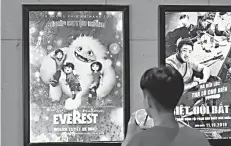  ?? — AFP file photo ?? A boy looks at a poster for the animated movie ‘Everest Nguoi Tuyet Be Nho’, also known as ‘Abominable’, at a movie theatre in Hanoi recently.