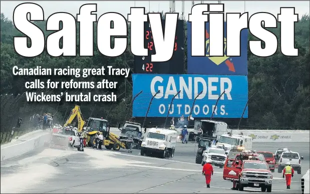  ?? — THE ASSOCIATED PRESS ?? Track workers repair a section of fence after Robert Wickens crashed during an IndyCar race at Pocono Raceway on Sunday.