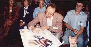  ?? FILE PIC ?? A participan­t signing a Kuala Lumpur World Poetry Reading poster in 1992.