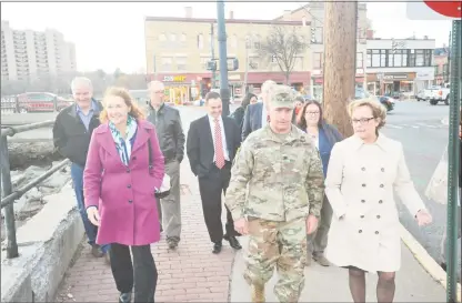  ?? Ben Lambert / Hearst Connecticu­t Media ?? U.S. Rep. Elizabeth Esty, D-Conn., left, Torrington Mayor Elinor Carbone, right, Col. Bill Conde, center, and other officials visited the Naugatuck River Tuesday to discuss the status of Torrington's efforts to restore its flood-protection system.