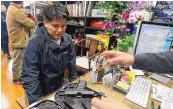  ?? RINGO H.W. CHIU/ASSOCIATED PRESS ?? Brian Xia, 44, buys a gun in Arcadia, Calif., on March 15, 2020. The state’s under-21 weapon sales ban violates the Second Amendment, a U.S appeals court has ruled.