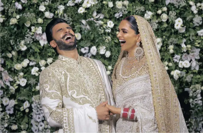  ??  ?? Bollywood darlings Ranveer Singh and Deepika Padukone hosted three reception parties in India. They are pictured above looking regal in ivory and gold. Deepika’s outfit is by Abu Jani-sandeep Khosla. She also wore a stunning red Zuhair Murad gown.