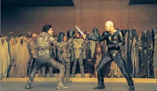  ?? Photograph­s by Niko Tavernise Warner Bros. Pictures ?? TIMOTHÉE CHALAMET, left, as Paul Atreides, squares off against Austin Butler, playing Feyd-Rautha Harkonnen, in an inevitable showdown in “Dune: Part Two.”