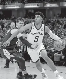  ?? AJ MAST/AP PHOTO ?? Kansas guard Quentin Grimes (5) goes around Michigan State guard Matt McQuaid (20) in the second half of men’s college basketball game Tuesday at the Champions Classic in Indianapol­is.