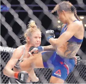  ?? FRANK FRANKLIN II/ASSOCIATED PRESS ?? Germaine de Randamie, right, punches Holly Holm during their featherwei­ght championsh­ip bout at UFC 208 in New York.