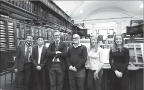  ?? PROVIDED TO CHINA DAILY ?? He Yizan (second left) with British Museum staff members. His company, Alfilo, has signed a licensing contract with the British Museum and the Palace Museum.