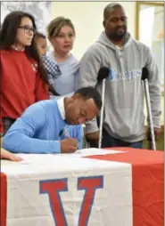  ?? PATRICK HOPKINS — THE NEWS-HERALD ?? VASJ senior Jerry Higgins signs his national letter of intent April 24 to play basketball and attend The Citadel.