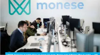  ??  ?? LONDON: Employees of mobile phone app-based ‘neo-bank’, Monese work at Monese office in London. — AFP