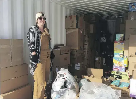  ??  ?? True North Aid supporter Bethany Diefenbake­r helps load donations headed to Onion Lake Cree Nation.