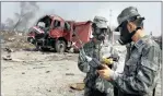  ?? PICTURE: REUTERS ?? DAMAGE CONTROL: Soldiers from the anti-chemical warfare corps work near a firefighti­ng vehicle at the site of Wednesday night’s explosions in Tianjin, China, yesterday.