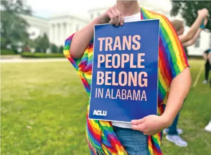  ?? AP PHOTO/KIM CHANDLER ?? In 2023, a person holds a sign during a rally outside the Alabama Statehouse in Montgomery, Ala.