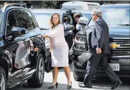  ?? Jacquelyn Martin ?? The Associated Press Canada’s Foreign Affairs Minister Chrystia Freeland, left, walks to a car during a break in trade talks Thursday in Washington. At right is David Macnaughto­n, Canada’s ambassador to the United States.