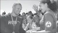  ?? ANDREW PALAMARCHU­K, METROLAND ?? Canadian sprinter Andre De Grasse meets with young fans during the Toronto District School Board elementary track and field championsh­ips at Birchmount Stadium last June.