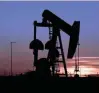  ?? — Reuters ?? A pump jack operates at sunset in an oil field in Midland, US.