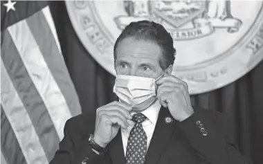  ?? DON POLLARD ?? New York Gov. Andrew Cuomo wears a mask before a briefing in New York City.