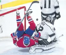  ?? RYAN REMIORZ/THE CANADIAN PRESS ?? Canadiens right winger Brendan Gallagher falls over Kings goalie Jonathan Quick during Montreal’s latest loss on Thursday. The Canadiens are, so far, second last in the NHL, ahead of only the winless Arizona Coyotes.