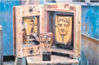  ?? Photo — AFP ?? A finished BAFTA (British Academy of Film and Television Arts) mask is pictured on a work bench after being cast during a photo call at the New Pro Foundries, west of London ahead of the British Academy Film Awards 2020.