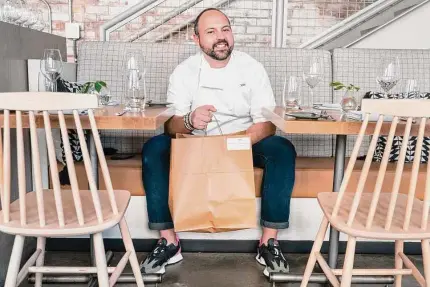  ?? Jacquelyn Martin/Associated Press ?? Matt Baker, chef and owner of Gravitas, inside the restaurant, on Feb. 14 in Washington. Gravitas has a subscripti­on service offering a monthly meal for two.