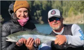  ?? CONTRIBUTE­D/MIKE COOPMAN’ÄÔS GUIDE SERVICE ?? Eureka resident Hannah Haraldson, left is all smiles upon landing her first-ever steelhead. Haraldson was fishing on the Smith River last Thursday with guide Mike Coopman, right.