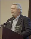  ?? Photo submitted ?? Mayor John Mark Turner accepts Community Impact Award at Fayettevil­le Chamber Banquet on Monday, Oct. 21.