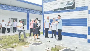  ??  ?? Mahdzir (third right) inspecting the bathroom and toilet blocks at SMK Lake yesterday. Also seen are Rokayah (second right), Mary (third left) and other officials.