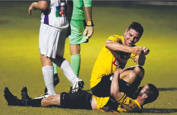  ??  ?? OAR-SOME: Edge Hill United’s Josh Taylor (top) celebrates a Josh De Nittis (bottom) goal during the Tigers’ FFA Cup win by turning his teammate into a kayak.