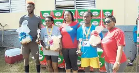 ?? PHOTO BY RICHARD BRYAN ?? Respective champions of the Fuss o August 5K Run/Walk event at the Mile Gully Community Center pose with their Kendel gift baskets and trophies. From left: Daniel Glaves, winner of the 5K run; Sonia Gayle, winner of the female 5K run; Keisha Cardoza,...