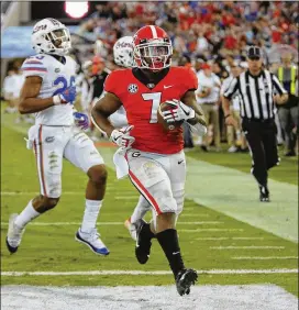  ?? BOB ANDRES / BANDRES@AJC.COM ?? Running back D’Andre Swift scores to cement Saturday’s 36-17 defeat of Florida that helped Georgia secure the No. 6 spot in the first CFP rankings.