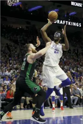  ?? MATT SLOCUM — THE ASSOCIATED PRESS ?? 76ers’ Joel Embiid (21) goes up for a shot against Boston Celtics’ Aron Baynes (46) during the first half of Game 3.