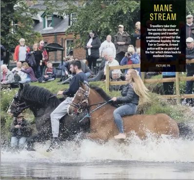  ??  ?? Travellers take their horses into the water as the gypsy and traveller community arrived for the traditiona­l Appleby Horse Fair in Cumbria. Armed police will be on patrol at the fair which dates back to medieval times.