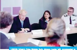  ??  ?? LONDON: Britain’s Prime Minister Boris Johnson (center left), accompanie­d by Britain’s Home Secretary Priti Patel, (center right), speaks at the first meeting of the National Policing Board at the Home Office yesterday. —AFP