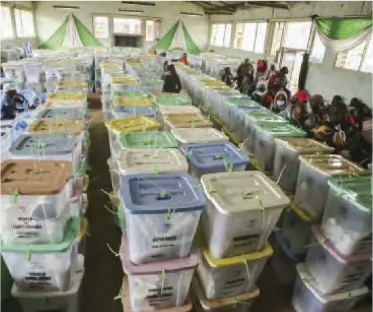  ?? ?? Electoral officials wait to hand over election results from their polling stations to the returning officer at Mathare Constituen­cy tallying centre in Nairobi, Kenya.