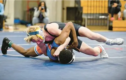  ?? PAUL W. GILLESPIE/BALTIMORE SUN MEDIA ?? Annapolis’ Jager Franz pins Old Mill’s Omar Khan to win the 120-pound match during the first round of the Class 4A East Region duals Tuesday.