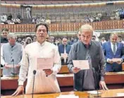  ?? AP ?? Imran Khan (left) takes oath of office in Parliament.