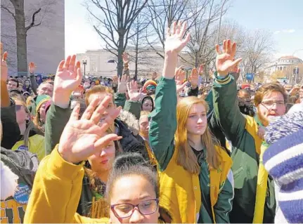  ?? KARL MERTON FERRON/BALTIMORE SUN ?? Students, alumni and parents from Great Mills High School raise their hands when speaker Zion Kelly, representi­ng Thurgood Marshall Academy in Washington, D.C., asks the crowd whether they knew anyone who died from gun violence.