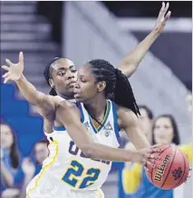  ?? Ringo H.W. Chiu Associated Press ?? UCLA GUARD Kennedy Burke keeps the ball away from a Texas A&M player during their second-round game.