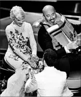  ?? CHRIS PIZZELLO/INVISION ?? Jimmy Kimmel, bottom, greets Helen Mirren and Jet Ski winner Mark Bridges during the Oscars on Sunday.