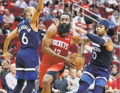  ?? Michael Wyke / Associated Press ?? Houston Rockets guard James Harden drives to the basket between Minnesota Timberwolv­es guard Jordans McLaughlin (6) and D’Angelo Russell during the second half of a game in March.