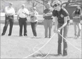  ?? Keith Bryant/The Weekly Vista ?? Incoming Chief James Graves, left, stands with Fire Chief Steve Sims, communicat­ions manager Cassi Lapp and Chief Ken Farmer while dispatcher Jennifer Whitfield tries to arrange a rope into a large square. Dispatcher Leslianne Pratt stands to the side.