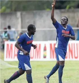  ??  ?? Devon Hodges (left) and Kesslan Hall of Mount Pleasant celebrate Hall’s second goal in the Eastern Confederat­ion final against Albion Mountain.