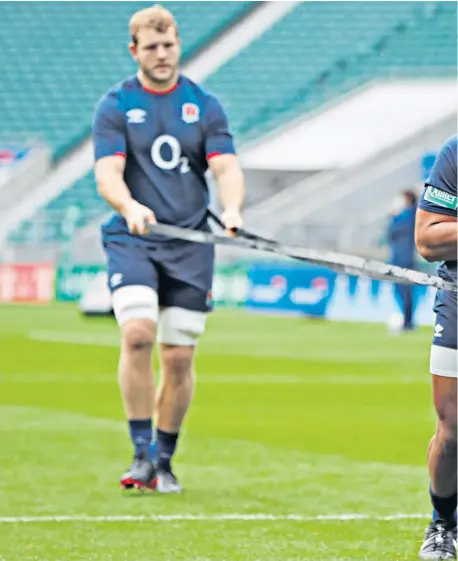  ??  ?? Pulling power: England No 8 Billy Vunipola works on his formidable leg drive with the help of lock Joe Launchbury at Twickenham yesterday