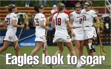  ?? MARY SCHWALM / BOSTON HERALD FILE ?? BIG SHOES TO FILL: Boston College players congratula­te teammate Sam Apuzzo (2) after she scored during the first half of a second-round NCAA game against Colorado on May 12, 2019.