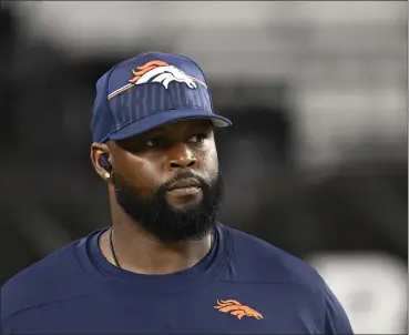  ?? RJ SANGOSTI — THE DENVER POST ?? Marcus Dixon, defensive line coach for the Broncos, watches warmups before a preseason game at State Farm Stadium on August 11in Glendale, Arizona.