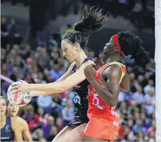  ?? PHOTO: GETTY IMAGES ?? Grabbing the game . . . Silver Ferns goal shoot Bailey Mes competes for the ball under pressure from England goal defence Ama Agbeze during the Quad Series match at the Liverpool Echo Arena yesterday.