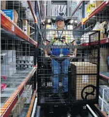  ?? THE ASSOCIATED PRESS ?? An Amazon employee works at the new Amazon warehouse in Boves, northern France. A new Amazon mega-warehouse opening in Carlsbad Springs today will provide 600 full-time jobs.