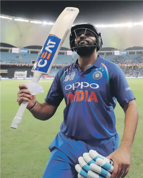  ?? Chris Whiteoak / The National ?? India captain Rohit Sharma soaks up the applause after his unbeaten 111 helped his team to a nine-wicket win over Pakistan yesterday. Sharma shared an opening stand of 210 with Shikhar Dhawan (114) at the Dubai Internatio­nal Cricket Stadium