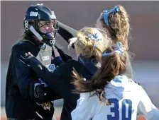  ?? STUART cAHILL / HeRALd sTAff fILe ?? ‘CAN SEE EVERYTHING’: Dover-Sherborn goaltender Sabrina Ryan (left) celebrates a win with teammates after a game in November 2019.